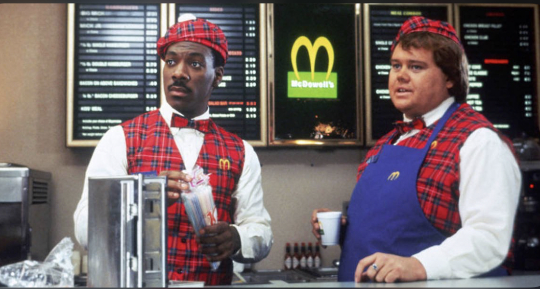 Akeem and Maurice behind the McDowell’s counter in Coming to America